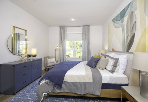 a bedroom with a bed and a dresser and a window at The Enclave, New Jersey